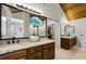 An elegant bathroom boasts double sinks, granite counters, and a gorgeous soaking tub at 2455 Anthony Ave, Clearwater, FL 33759
