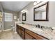 Bathroom with double sink vanity and granite countertops, complemented by modern fixtures and a large framed mirror at 2455 Anthony Ave, Clearwater, FL 33759