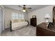 Cozy bedroom with neutral tones, a daybed with decorative pillows, and a window with plantation shutters at 2455 Anthony Ave, Clearwater, FL 33759