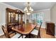 Formal dining room with a large wooden table, a china cabinet, and shuttered windows at 2455 Anthony Ave, Clearwater, FL 33759