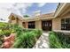 Inviting home entrance featuring a well-manicured lawn, lush landscaping, and a tiled roof at 2455 Anthony Ave, Clearwater, FL 33759