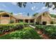Charming single-story home with a well-manicured lawn, mature landscaping, and a tile roof at 2455 Anthony Ave, Clearwater, FL 33759