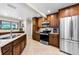This kitchen boasts granite counters, wooden cabinets, and stainless steel appliances at 2455 Anthony Ave, Clearwater, FL 33759