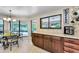 A charming dining area and granite-countered kitchen shows views of the pool at 2455 Anthony Ave, Clearwater, FL 33759