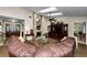 Spacious living room featuring a brick fireplace, skylights, and a comfortable brown leather couch at 2455 Anthony Ave, Clearwater, FL 33759