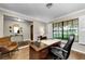 Inviting office with a large desk, chair, and natural light from a large window overlooking the landscaped front yard at 2455 Anthony Ave, Clearwater, FL 33759