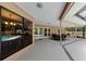 Spacious covered patio with dining set offering views of a pool and landscaped yard through large windows at 2455 Anthony Ave, Clearwater, FL 33759