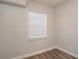 Bright bedroom featuring modern flooring, a window with blinds, and efficient mini-split AC unit at 2926 Fairfield S Ave, St Petersburg, FL 33712