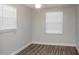 Bright bedroom featuring modern flooring, two windows with blinds, and a ceiling fan at 2926 Fairfield S Ave, St Petersburg, FL 33712