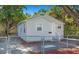 Charming single-story home with a neutral color scheme and a well-maintained yard behind a chainlink fence at 2926 Fairfield S Ave, St Petersburg, FL 33712
