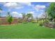 Expansive backyard with a well-maintained lawn, mature trees, and colorful flowerbeds enhancing outdoor enjoyment at 3026 Cedaridge Dr, Tampa, FL 33618