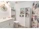 Coastal-themed bathroom featuring a white vanity, toilet, shelving, and mermaid decor at 3026 Cedaridge Dr, Tampa, FL 33618
