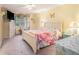 Bright bedroom with yellow walls, floral bedding, and window with patterned curtains at 3026 Cedaridge Dr, Tampa, FL 33618