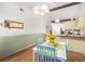 Charming dining area with sunflower decor, wood-look flooring, and decorative mirror at 3026 Cedaridge Dr, Tampa, FL 33618