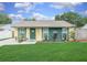 Charming home featuring a well-manicured lawn, a welcoming door, and lovely curb appeal at 3026 Cedaridge Dr, Tampa, FL 33618