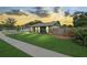 Charming home with a manicured lawn, flower beds, and a welcoming walkway in a serene neighborhood at 3026 Cedaridge Dr, Tampa, FL 33618