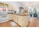 Bright kitchen with ample counter space, white appliances, and a cozy dining area in the background at 3026 Cedaridge Dr, Tampa, FL 33618