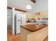 Functional kitchen with ample counter space, white appliances, and wood-look flooring at 3026 Cedaridge Dr, Tampa, FL 33618