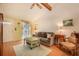 Cozy living room with a comfortable sofa, natural light, and vaulted ceilings with beams at 3026 Cedaridge Dr, Tampa, FL 33618