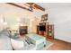 Inviting living room with a fireplace, entertainment center, and vaulted ceilings with beams at 3026 Cedaridge Dr, Tampa, FL 33618