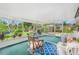 Relaxing screened patio offers serene views of the beautifully landscaped backyard at 3026 Cedaridge Dr, Tampa, FL 33618