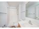 Bright bathroom with white shower, tile floor, white walls, modern sink, mirror, and hardware at 3443 Fyfield Court, Land O Lakes, FL 34638