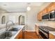 Bright kitchen with stainless steel appliances, wooden cabinets, and stylish breakfast bar at 3443 Fyfield Court, Land O Lakes, FL 34638