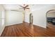 Bright, open living area with hardwood floors, vaulted ceiling and arched doorway at 3443 Fyfield Court, Land O Lakes, FL 34638