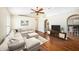 Spacious living room with hardwood floors, vaulted ceiling, ceiling fan and comfortable sectional sofa at 3443 Fyfield Court, Land O Lakes, FL 34638