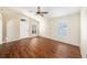 Bright living room with hardwood floors, vaulted ceiling, and large windows with plantation shutters at 3443 Fyfield Court, Land O Lakes, FL 34638