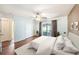 Well-lit main bedroom featuring neutral carpeting, ceiling fan, and glass sliding door to a patio at 3443 Fyfield Court, Land O Lakes, FL 34638