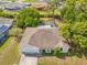 Aerial view of the home, showing its layout, neighboring properties, pool, and landscaping at 3485 Dothan Ave, Spring Hill, FL 34609