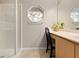 Bathroom featuring a glass-enclosed shower and octagonal window above the vanity at 3485 Dothan Ave, Spring Hill, FL 34609
