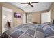 Bedroom showcasing a TV, fan, vaulted ceiling, window, and door at 3485 Dothan Ave, Spring Hill, FL 34609