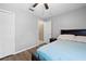 Simple bedroom with a closet, bed, nightstand, and an open doorway at 3485 Dothan Ave, Spring Hill, FL 34609