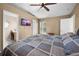 Bedroom showcasing a TV, fan, vaulted ceiling, window, and door at 3485 Dothan Ave, Spring Hill, FL 34609
