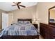 Bedroom featuring a bed, dresser, and nightstand in neutral tones at 3485 Dothan Ave, Spring Hill, FL 34609
