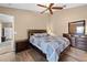 Bedroom featuring wood floors, ceiling fan, bed, dresser, and nightstand at 3485 Dothan Ave, Spring Hill, FL 34609