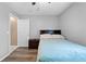 Cozy bedroom with a comfortable bed, nightstand, and an open doorway at 3485 Dothan Ave, Spring Hill, FL 34609