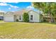 A single-story home with a well-maintained lawn, mature trees, and an attached two-car garage at 3485 Dothan Ave, Spring Hill, FL 34609