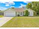 Charming single-story home with a well-manicured lawn and attached two-car garage at 3485 Dothan Ave, Spring Hill, FL 34609