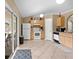 Kitchen features tile floors, appliances, wood cabinets, and a sliding glass door at 3485 Dothan Ave, Spring Hill, FL 34609