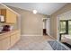 Bright kitchen showcases tile floors, light wood cabinets, and seamless access to the outdoors through sliding glass doors at 3485 Dothan Ave, Spring Hill, FL 34609