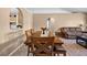 Open-concept living and dining area featuring tile floors, traditional furniture, and arched doorways at 3485 Dothan Ave, Spring Hill, FL 34609