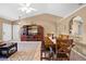 Open living space showcasing tile flooring, comfortable seating, a dining area, and a media center at 3485 Dothan Ave, Spring Hill, FL 34609