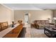 Inviting living room and dining area featuring comfortable seating, a dining table, and an arched doorway to a bathroom at 3485 Dothan Ave, Spring Hill, FL 34609