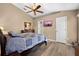 Inviting main bedroom features a ceiling fan, wood floors, and neutral paint tones at 3485 Dothan Ave, Spring Hill, FL 34609