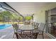 Relax on the outdoor patio overlooking the pool and lush backyard, perfect for entertaining guests at 3485 Dothan Ave, Spring Hill, FL 34609