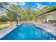 Screened-in pool area offers relaxation and recreation in this outdoor oasis with patio seating at 3485 Dothan Ave, Spring Hill, FL 34609
