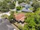 Overhead view of the home with a red roof, highlighting the backyard, screened patio, and surrounding neighborhood at 3529 Orion Rd, Spring Hill, FL 34606